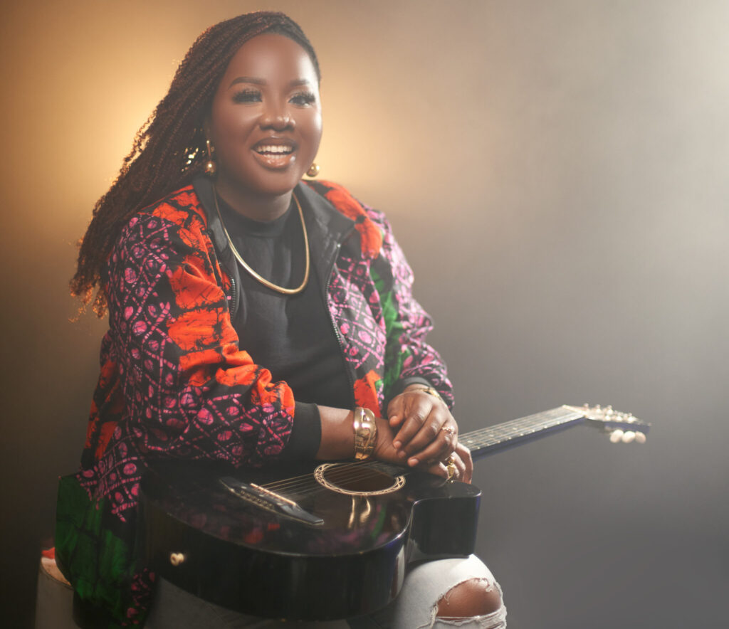 this is the international multi award winning queen of afro folk blessing tangban Can you help me with 1. An alt text for the image. 2. a caption for the image? 3. A description for the image. This image is to be used as the featured image for an article, so SEO should be top-notch